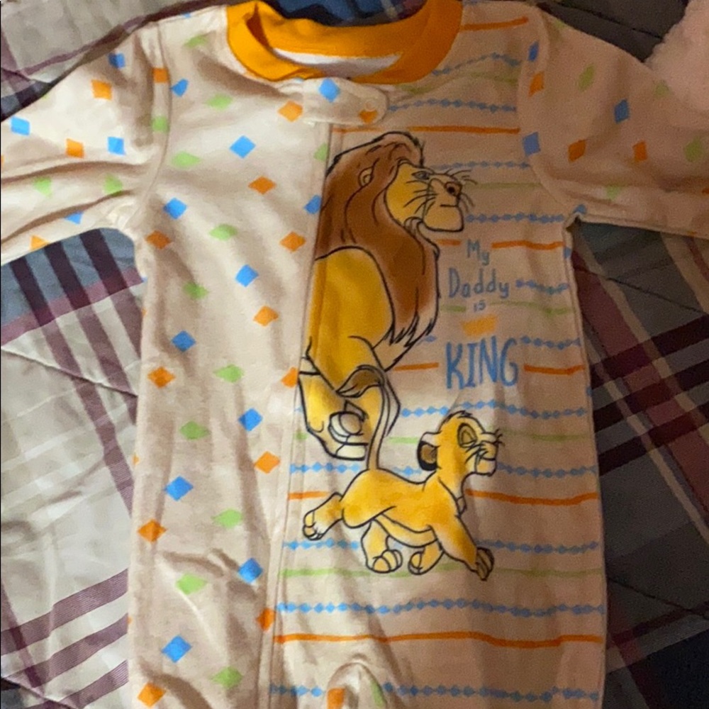 A baby boy pajama onesie that is lion king themed